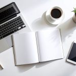 Modern table scene with open catalog mockup, coffee and green plant