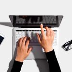 Person using a laptop computer from above